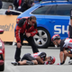 Teammates tend to Australia’s Caleb Ewan after he crashed in the sprint towards the finish line of the third stage of the Tour de France.
